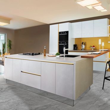 Modern kitchen with a sleek island and yellow accent wall.