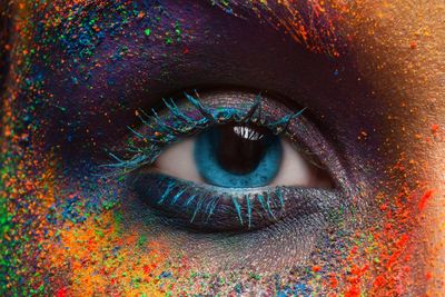 Artist Eye with rainbow of colors across her skin