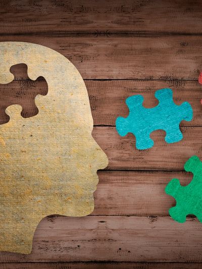 Neurodiversity autism executive function skills with wooden puzzle of human profile.