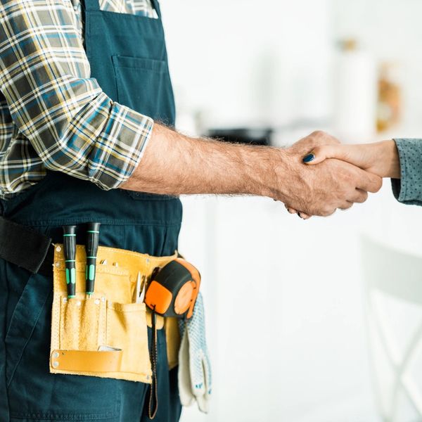 Handyman shaking hands with a customer.