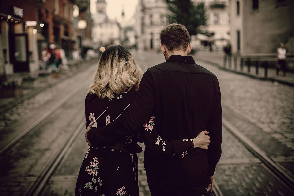 Couple walking down a city street on a date together. 