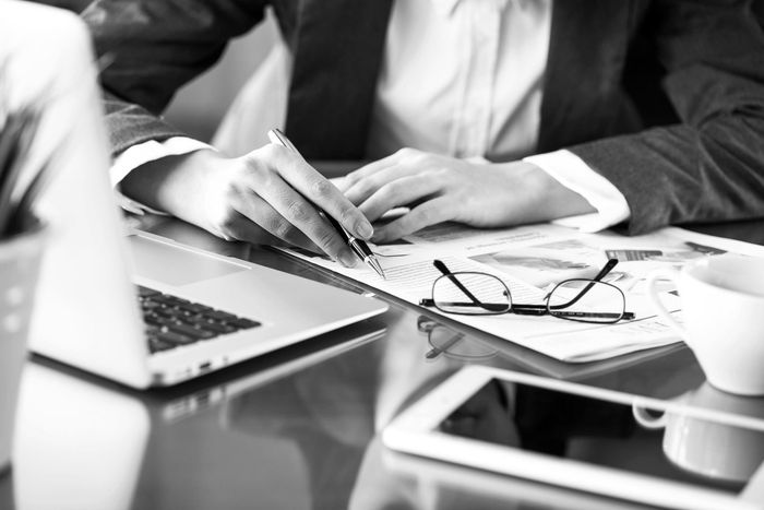 Women working at desk with computer and paperwork