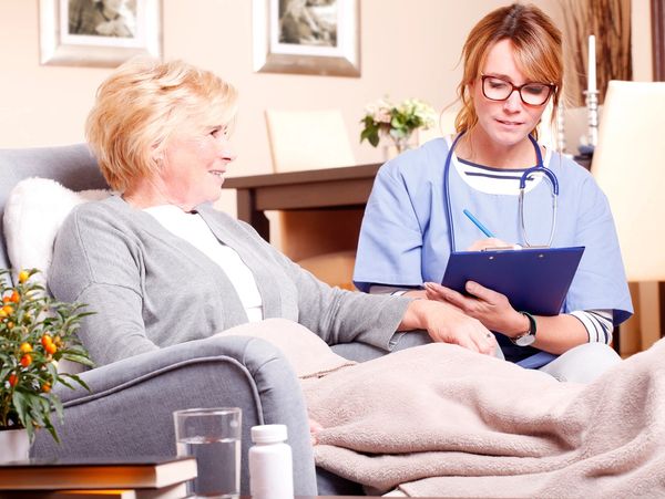 Care taker helping an elder woman.