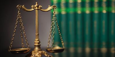 A close-up of a golden balance scale symbolizing justice.