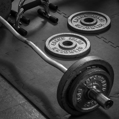 Barbell and plates on Gym floor