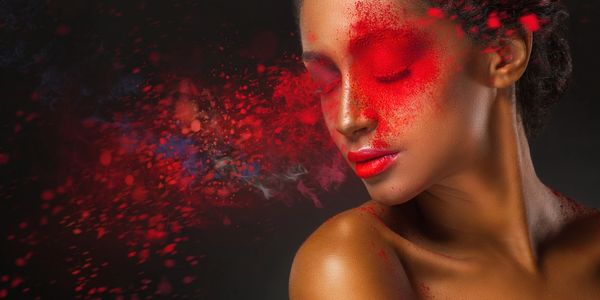 A person with red powder on her eyes