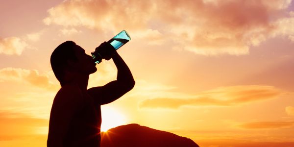 Man drinking cold bottled purified water.