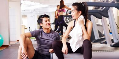 Two people talking at the gym
