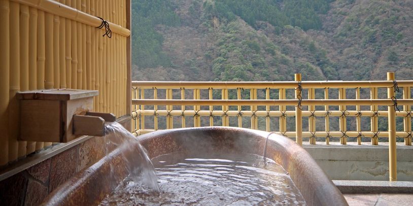 stone hot tub with clean water overlooking the mountains 