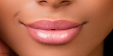 lady with fitz 5 skin and peachy pink smile, defined brows, with yellow background