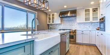 Newly remodeled kitchen with bluish countertops and cabinets.