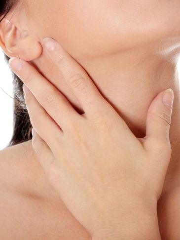 Close-up of a hand touching the side of a neck.