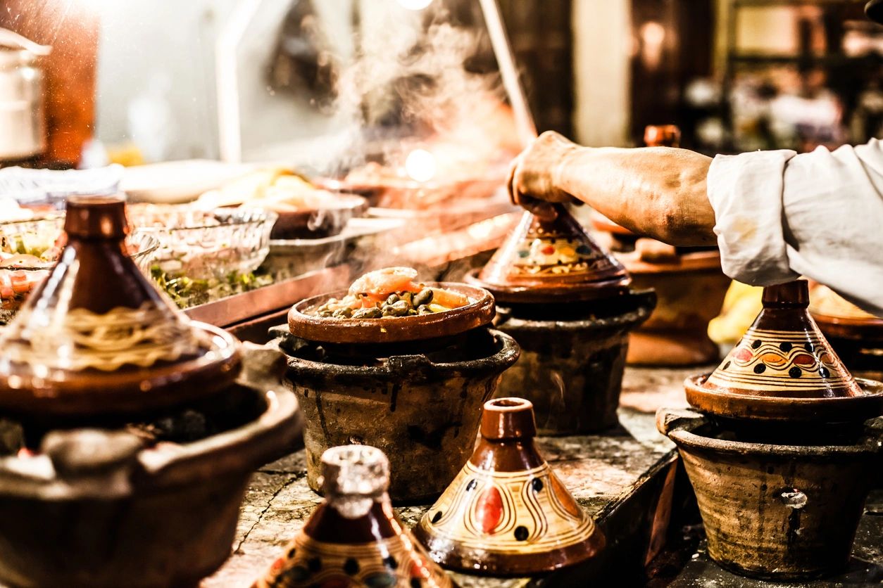 Steaming Moroccan tagine pots cooking vibrant dishes.
