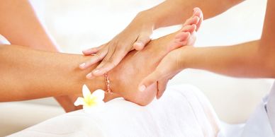 A left foot having massage therapy applied. 