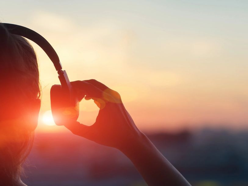 person listening to music via headphones