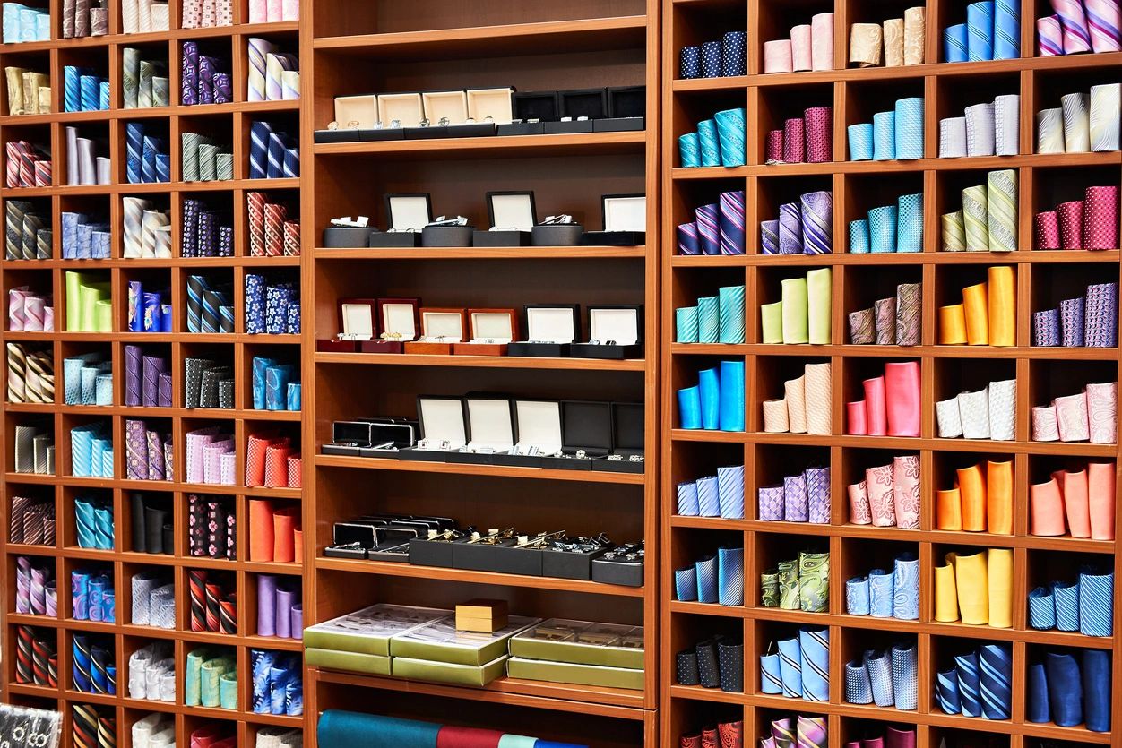 Shelves filled with colorful ties and cufflinks in a store.