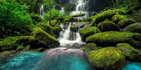 Waterfall surrounded by rocks covered in moss