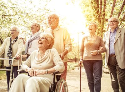 Elderly smiling and laughing while walking in a Park