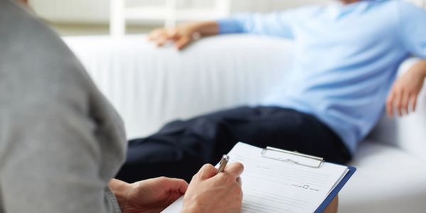 Person sitting on couch during therapy session