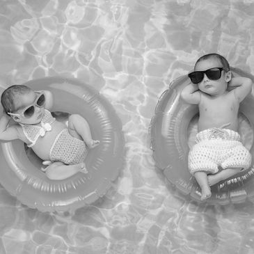 babies sleeping in a pool floaty with sunglasses on