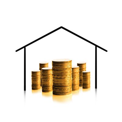 Stacks of coins inside a house outline symbolizing home investment.