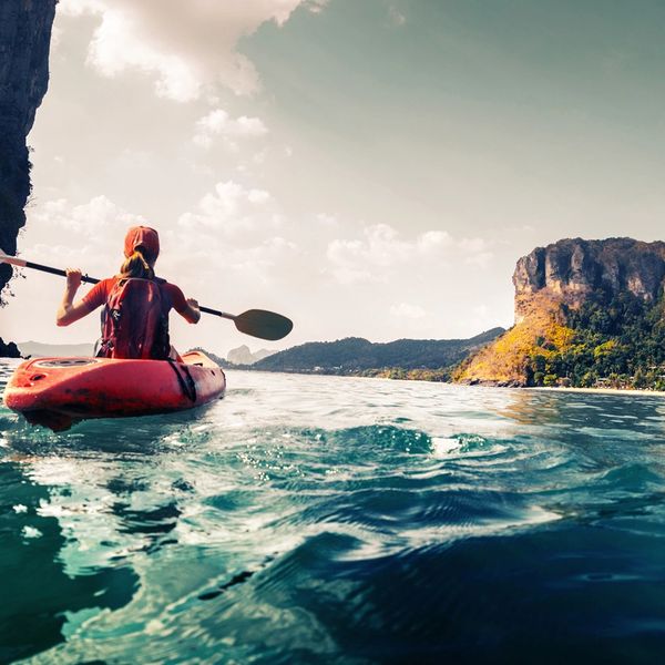 Woman kayaking in blue waters