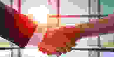 Businessman and woman shaking hands.