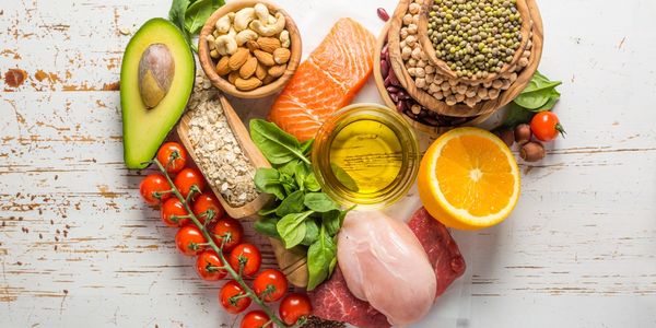 A selection of nutritious foods displayed in a heart shape.