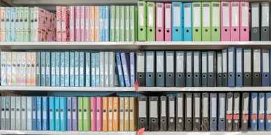 Organized file folders on a bookshelf