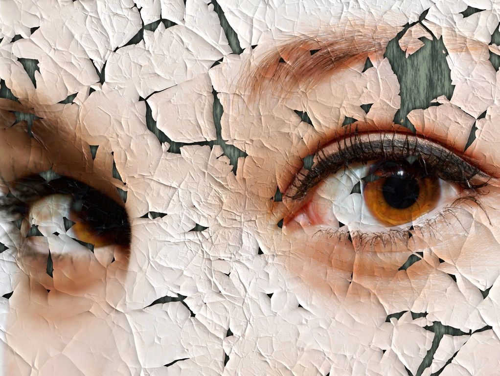 Mental Health Cracked painting of a female eyes