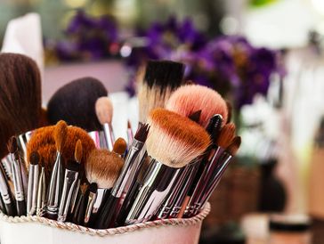 A collection of various makeup brushes in a holder.