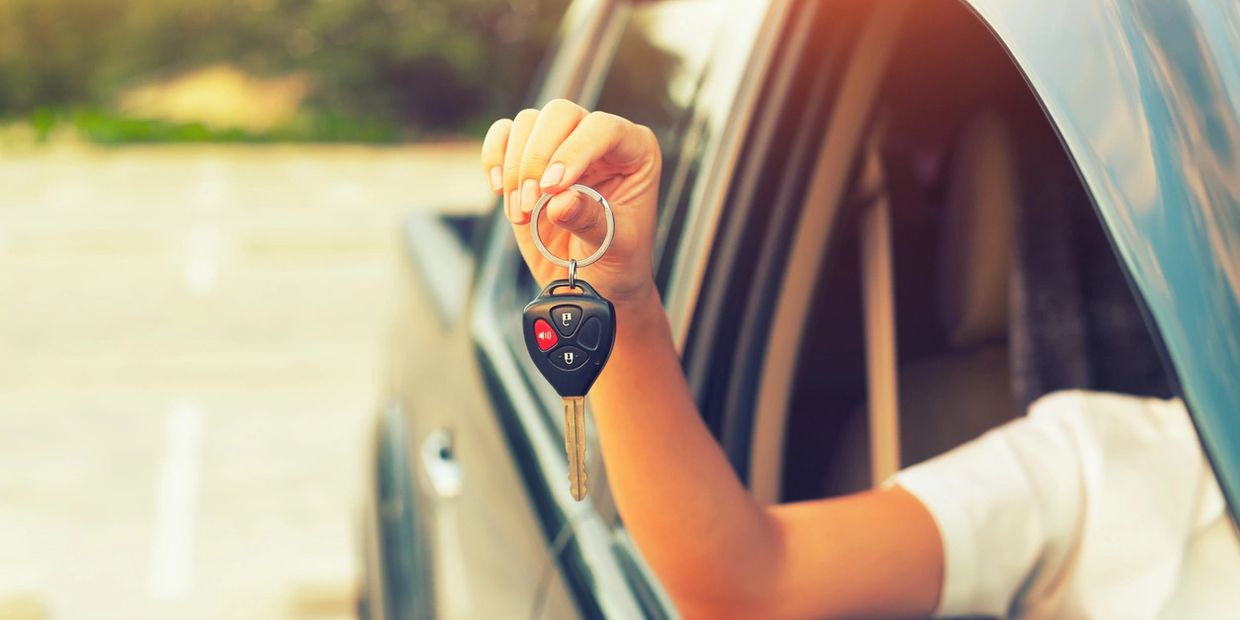 Customer happily showing her car key.