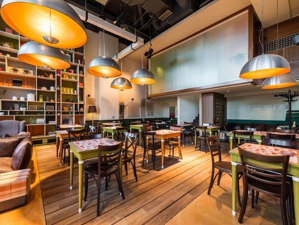 Cozy modern restaurant with warm lighting and wooden floors.