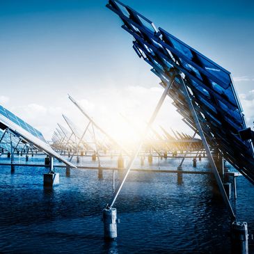 Solar panels installed over water, reflecting sunlight.