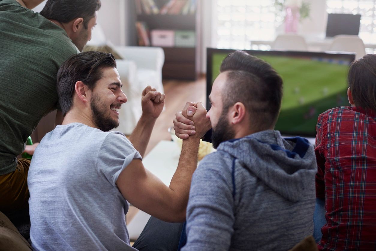 Friends share a moment celebrating a win with a handshake.