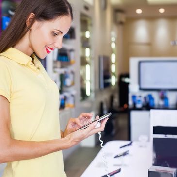 Woman trying out a smartphone in a store.