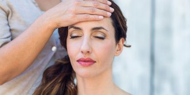 A woman enjoying Traditional Head Massage Therapy.