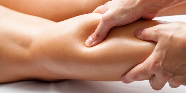 Therapist massaging a person's calf.