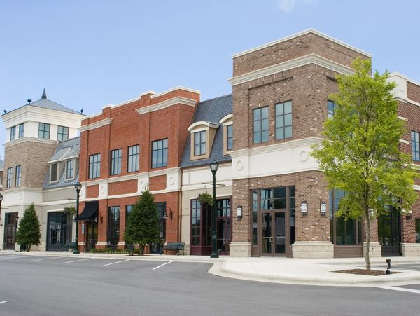 Modern commercial buildings with brick facades under a clear sky.