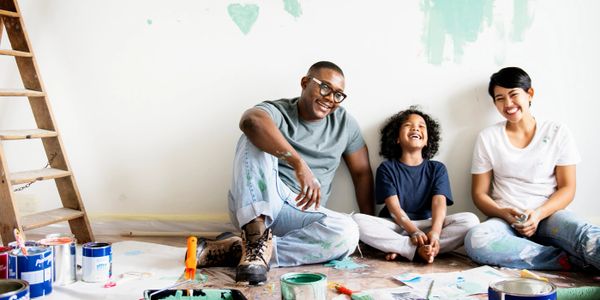 Family taking a break from painting their home