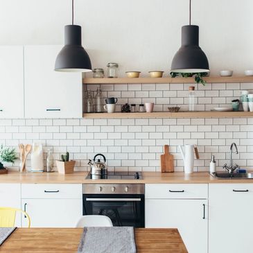 sleek and modern kitchen with white cabinets and open shelving