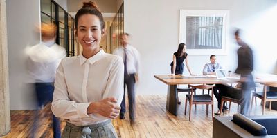 Businesswoman with arms crossed smiling 