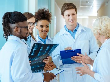 Medical team discussing X-ray results together.