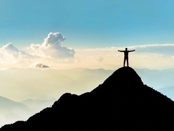 A successful hiker who was summited a mountain. 