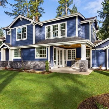 Blue two story house with white gutters around the roof line