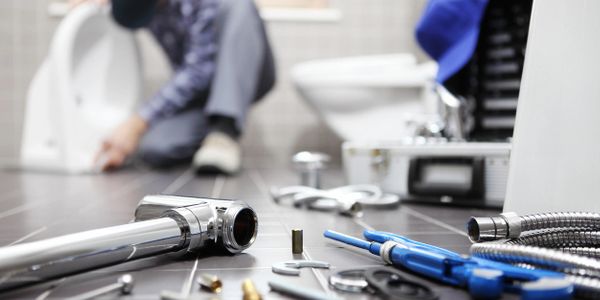 Plumbing technician installing a lavatory sink. 