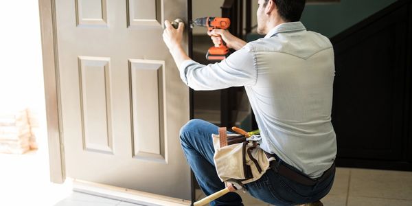 Shows a man changing a door lock.