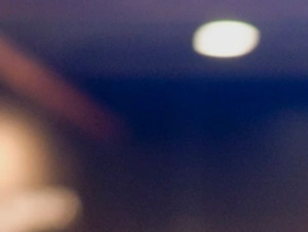 Blurred image with indistinct shapes and lights.