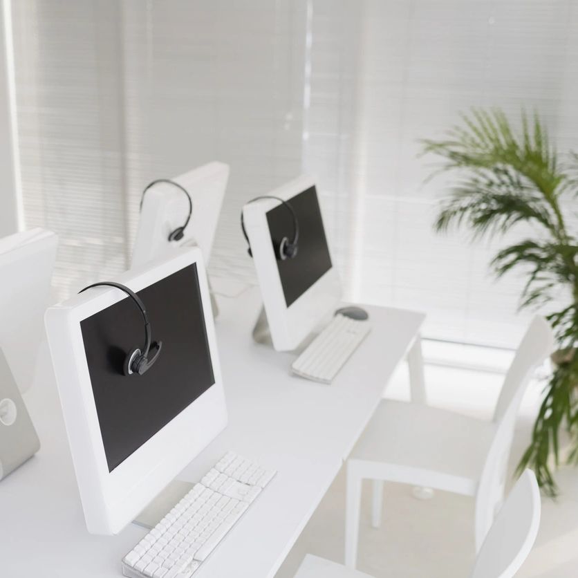 White Computers with Headests in a room